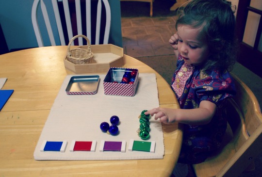 Montessori Christmas Activities for Toddlers - Matching Ornaments to Colored Tablets